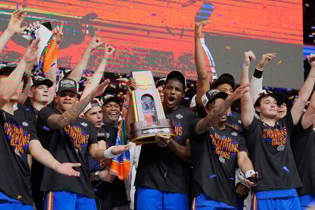 Florida players celebrate with the trophy after they defeated Houston in the national championship game on Monday, April 7.
