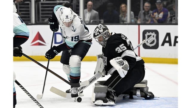Seattle Kraken left wing Jared McCann, left, vies for the puck against Kings goaltender Darcy Kuemper during the first period on Monday night at Crypto.com Arena. The Kings lost, 2-1. (AP Photo/Alex Gallardo)