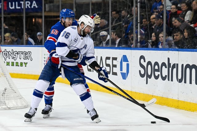 Apr 7, 2025; New York, New York, USA;  New York Rangers left wing Will Cuylle (50) gets called for holding on Tampa Bay Lightning right wing Nikita Kucherov (86) during the third period at Madison Square Garden. Mandatory Credit: Dennis Schneidler-Imagn Images