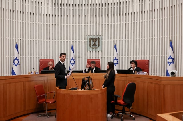 Chief Justice Yitzhak Amit and fellow Israeli Supreme Court judges preside over a hearing on the government's dismissal of the head of the Shin Bet domestic intelligence service, Ronen Bar, at the high court in Jerusalem April 8, 2025. REUTERS/Ronen Zvulun