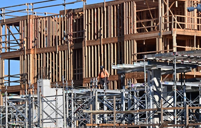 A construction worker is seen on the site of a new development in San Gabriel, California, on March 24, 2025. Home builders could face higher costs due to tariffs enacted by US President Trump. More than 70% of softwood lumber and gypsum are imported to the US from Canada and Mexico, according to the National Association of Home Builders.