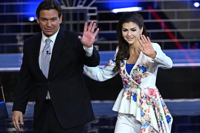 Florida Governor Ron DeSantis (L) and his wife Casey DeSantis wave as they depart the third Republican presidential primary debate at the Knight Concert Hall at the Adrienne Arsht Center for the Performing Arts in Miami, Florida, on November 8, 2023.