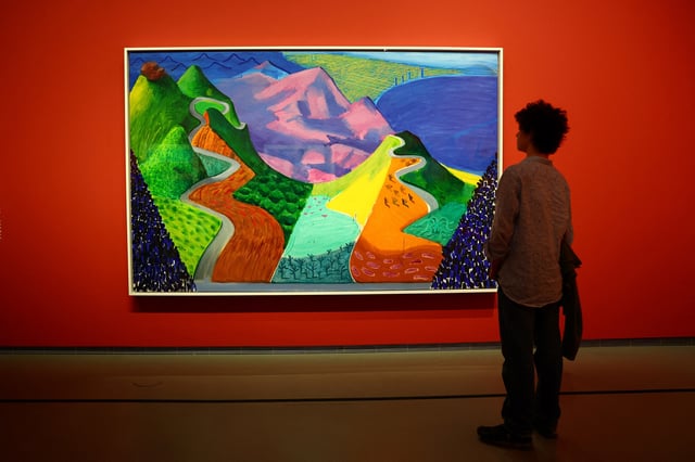A visitor looks at the painting "Pacific Coast Highway and Santa Monica, 1960" by British painter David Hockney during a press visit ahead of the opening of the exhibition "David Hockney 25" at the Fondation Louis Vuitton in Paris, France, April 8, 2025. REUTERS/Gonzalo Fuentes
