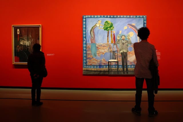 Visitors look at the paintings "Going to be a Queen for Tonight, 1960" and "Play Within a Play, 1963" by British painter David Hockney during a press visit ahead of the opening of the exhibition "David Hockney 25" at the Fondation Louis Vuitton in Paris, France, April 8, 2025. REUTERS/Gonzalo Fuentes