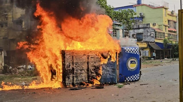 Smoke and flames billow out from a vehicle after it was set ablaze during a protest over the Waqf (Amendment) Act in Murshidabad district of West Bengal on Tuesday (PTI)