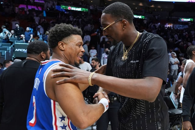 Philadelphia 76ers guard Kyle Lowry (7) greets Miami Heat center Bam Adebayo, right, after an NBA basketball game, Monday, April 7, 2025, in Miami. (AP Photo/Lynne Sladky)