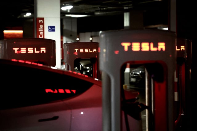A Tesla electric vehicle is charged at a Tesla Supercharger battery charging station in Barakaldo, Spain, March 29, 2025. REUTERS/Vincent West/File Photo