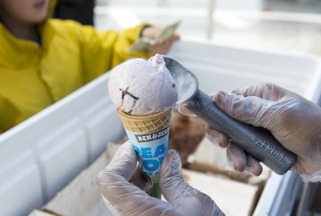An employee of Ben & Jerry's scoops ice cream into a cone outside Union Station in Washington on June 18, 2013.     
