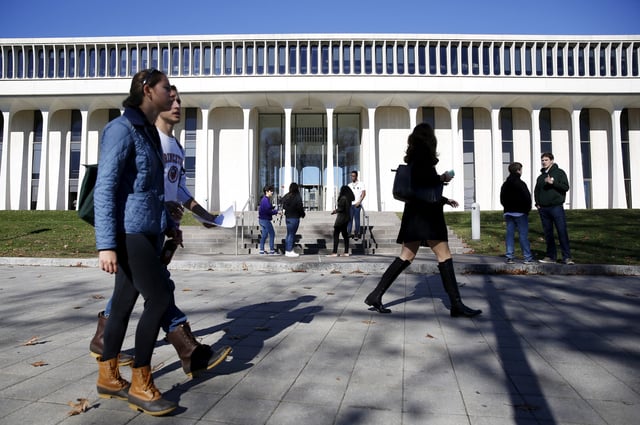 People walk past Princeton University's Woodrow Wilson School of Public and International Affairs in Princeton, New Jersey, November 20, 2015. Princeton University has pledged to consider renaming buildings dedicated to former U.S. President Woodrow Wilson, the latest U.S. campus effort to quell student complaints of racism. REUTERS/Dominick Reuter/File Photo