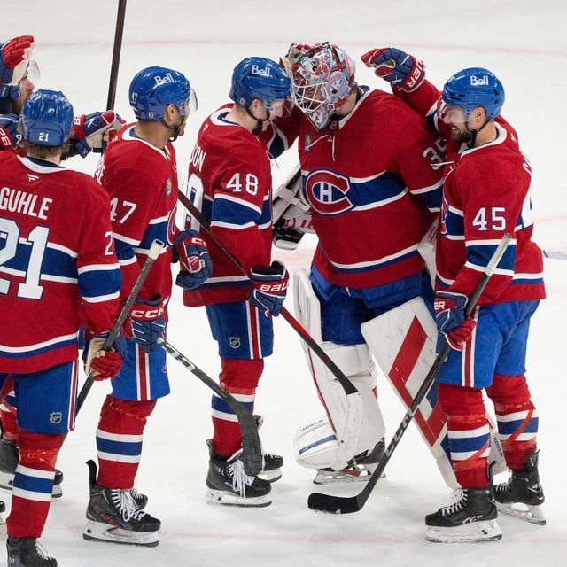 Montreal Canadiens surround goaltender Sam Montembeault (35) to celebrate their win over Detroit Red Wings following third period NHL hockey action in Montreal on Tuesday, April 8, 2025. THE CANADIAN PRESS/Christinne Muschi