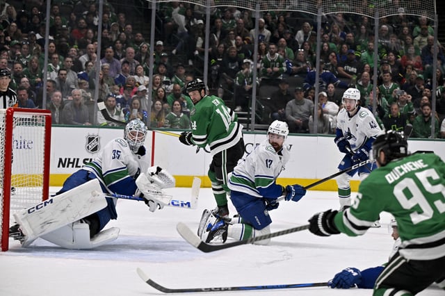 Apr 8, 2025; Dallas, Texas, USA; Dallas Stars center Matt Duchene (95) scores a goal past Vancouver Canucks goaltender Thatcher Demko (35) as left wing Jamie Benn (14) looks on during the second period at the American Airlines Center. Mandatory Credit: Jerome Miron-Imagn Images
