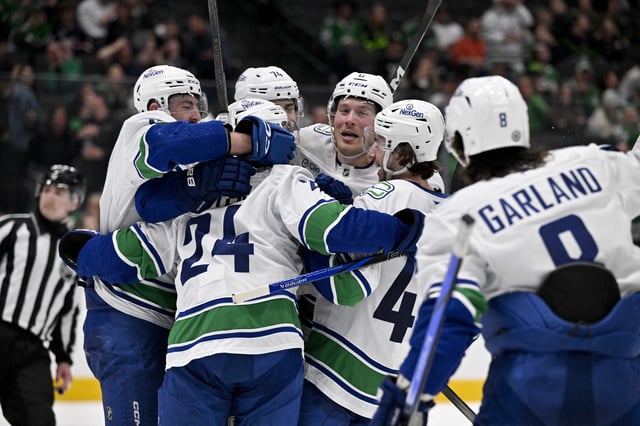 Apr 8, 2025; Dallas, Texas, USA; Vancouver Canucks left wing Jake DeBrusk (74) and center Pius Suter (24) and right wing Brock Boeser (6) and right wing Conor Garland (8) and defenseman Filip Hronek (17) and defenseman Quinn Hughes (43) celebrates the game tying goal scored by Suter against the Dallas Stars during the third period at the American Airlines Center. Mandatory Credit: Jerome Miron-Imagn Images