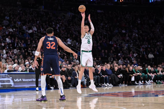 Apr 8, 2025; New York, New York, USA; Boston Celtics center Kristaps Porzingis (8) shoots the ball while being defended by New York Knicks center Karl-Anthony Towns (32) during the second half at Madison Square Garden. Mandatory Credit: John Jones-Imagn Images