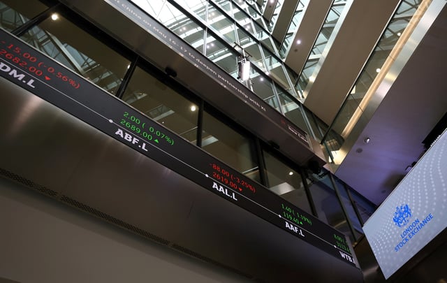 A trading screen is seen in the lobby of the London Stock Exchange in London, Britain, May 14, 2024. REUTERS/Hannah McKay/File photo