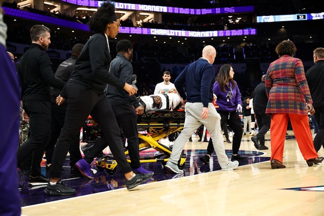 Wells is taken from the court following his injury.