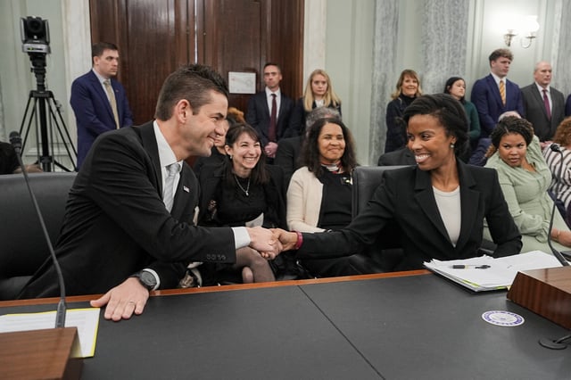 Jared Isaacman, U.S. President Donald Trump's nominee to be administrator of the National Aeronautics and Space Administration (NASA), shakes hands with Olivia Trusty, nominee to be a member of the Federal Communications Commission, before testifying during a Senate Commerce, Science, and Transportation confirmation hearing on Capitol Hill in Washington, D.C., U.S., April 9, 2025. REUTERS/Ken Cedeno