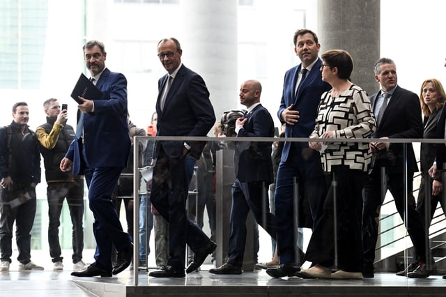 Germany's chancellor-in-waiting and leader of the Christian Democratic Union party (CDU) Friedrich Merz, Christian Social Union (CSU) leader and Bavarian Premier Markus Soeder, co-leaders of the Social Democratic party (SPD) Saskia Esken and Lars Klingbeil walk to attend a press conference after reaching an agreement on their coalition government in Berlin, Germany, April 9, 2025. REUTERS/Annegret Hilse/File Photo