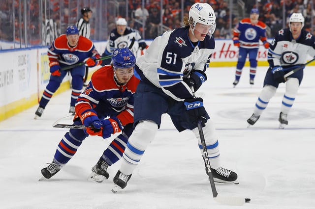 Sep 25, 2022; Edmonton, Alberta, CAN; Winnipeg Jets forward Chaz Lucius (51) makes a pass in front Edmonton Oilers forward Xavier Bourgault (54) during the third period at Rogers Place. Mandatory Credit: Perry Nelson-USA TODAY Sports/ File Photo
