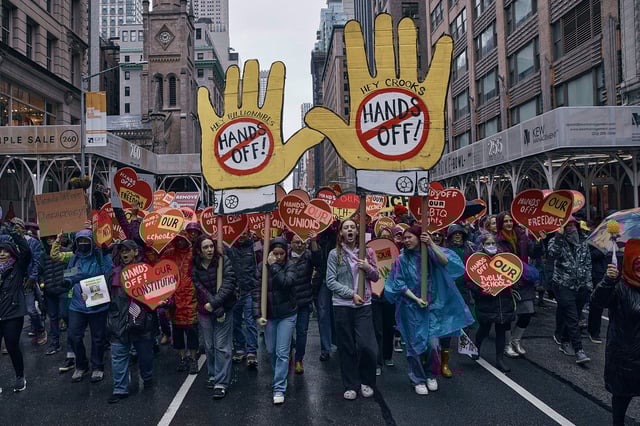 Protestors march during a "Hands Off!" protest against President Donald Trump on Saturday.