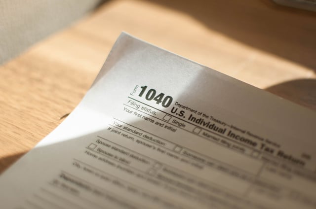 A close-up view of tax form on a wooden table