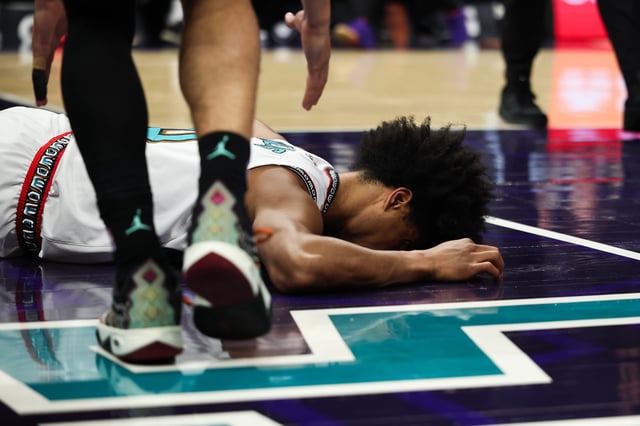 aylen Wells #0 of the Memphis Grizzlies lays on the court after an injury during the first half of a basketball game against the Charlotte Hornets. He would leave the game on a stretcher.