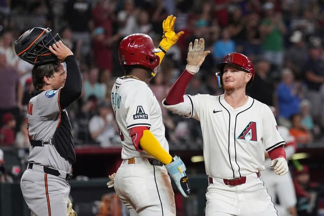 Arizona Diamondbacks&#39; Pavin Smith, right, celebrates his two-run home run with Diamondbacks&#39; Geraldo Perdomo, center, as Baltimore Orioles catcher Adley Rutschman, left, pauses at home plate during the fifth inning of a baseball game Wednesday, April 9, 2025, in Phoenix. (AP Photo/Ross D. Franklin)