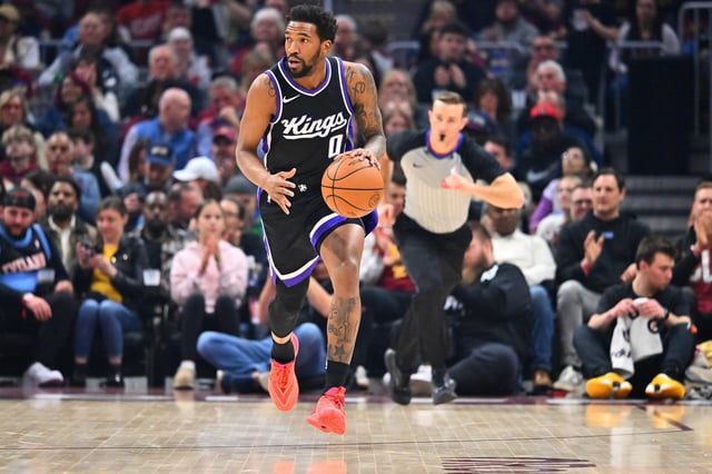 Malik Monk #0 of the Sacramento Kings brings the ball up court during the first quarter against the Cleveland Cavaliers at Rocket Arena on April 06, 2025 in Cleveland, Ohio.