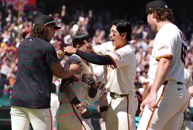 Mike Yastrzemski of the San Francisco Giants celebrates with Jung Hoo Lee and his teammates after hitting a two-run walk-off home run to defeat the Cincinnati Reds 8-6 at San Francisco’s Oracle Park on April 9, 2025. 