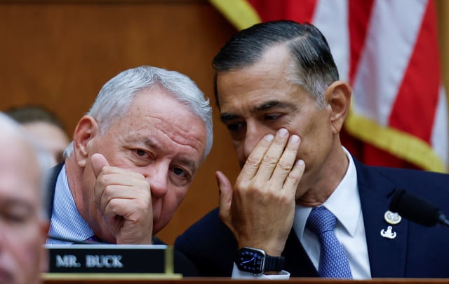 U.S. Representatives Ken Buck (R-CO) and Darrell Issa (R-CA) whisper to each other as U.S. Attorney General Merrick Garland testifies before a House Judiciary Committee hearing on the "Oversight of the U.S. Department of Justice" on Capitol Hill in Washington, U.S., September 20, 2023. REUTERS/Evelyn Hockstein
