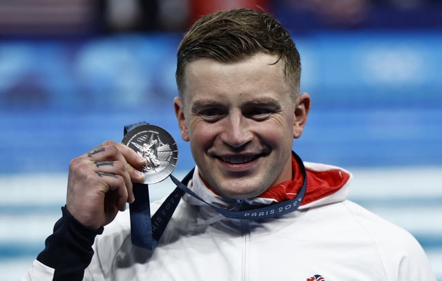 Paris 2024 Olympics - Swimming - Men's 100m Breaststroke Victory Ceremony - Paris La Defense Arena, Nanterre, France - July 28, 2024.  Silver medallist Adam Peaty of Britain celebrates. REUTERS/Clodagh Kilcoyne