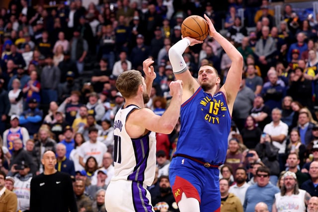 Nikola Jokic #15 of the Denver Nuggets shoots against Domantas Sabonis #11 of the Sacramento Kings at Ball Arena on January 23, 2025 in Denver, Colorado.