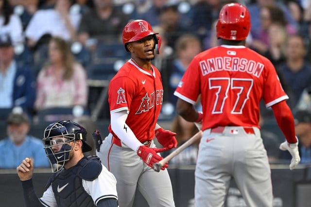 The Angels’ Kyren Paris, center, is congratulated at home plate by teammate Tim Anderson after hitting a solo home run as Tampa Bay Rays catcher Danny Jansen, left, looks on during the second inning on Wednesday night in Tampa, Fla. Paris hit two solo homers in the Angels’ 5-4 loss. (AP Photo/Phelan M. Ebenhack)