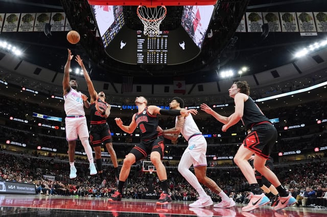 Miami Heat guard Davion Mitchell, left, shoots against Chicago Bulls forward Dalen Terry (25) during the first half of an NBA basketball game in Chicago, Wednesday, April 9, 2025. (AP Photo/Nam Y. Huh)