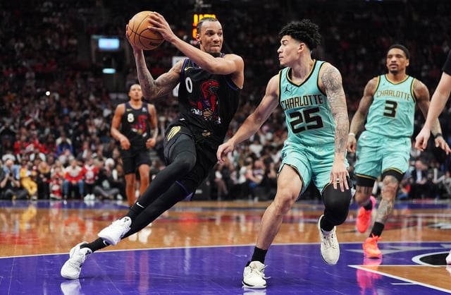 Toronto Raptors' A.J. Lawson (0) drives past Charlotte Hornets' KJ Simpson (25) during second half NBA basketball action in Toronto on Wednesday, April 9, 2025. THE CANADIAN PRESS/Frank Gunn