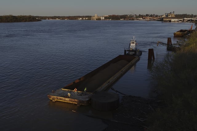 A crew works to move coal down the Ohio River on Tuesday, April 8, 2025, in Evansville, Ind. (AP Photo/Joshua A. Bickel)