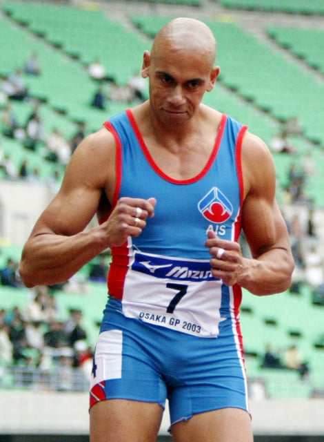 Australian sprinter Patrick Johnson finishes the men's 100 metres final at the IAAF Japan Grand Prix 2003 track and field meet in Osaka, western Japan May 10, 2003. Tim Montgomery of United States won the race in 10.04 seconds while Johnson placed second with 10.05 seconds. REUTERS/Issei Kato/File Photo