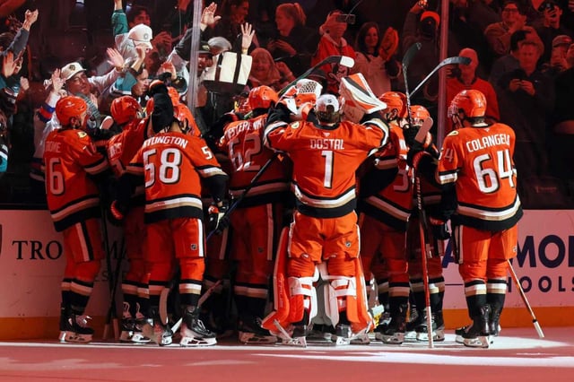Ducks players celebrate after their 4-3 overtime victory against the Calgary Flames on Wednesday night at Honda Center. (AP Photo/Etienne Laurent)