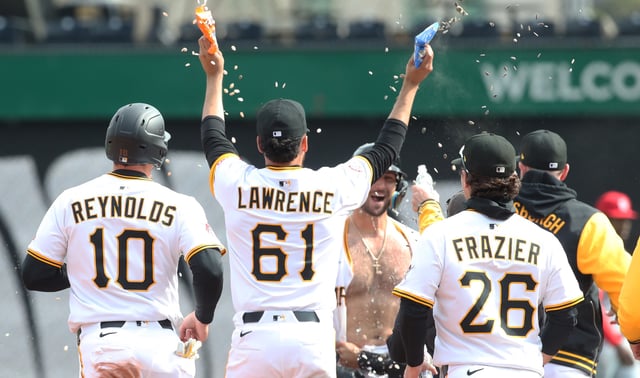 Apr 9, 2025; Pittsburgh, Pennsylvania, USA;  Pittsburgh Pirates teammates celebrate with catcher Joey Bart (shirtless) after Bart hit a game winning walk off single to defeat the St. Louis Cardinals in the thirteenth inning at PNC Park. Mandatory Credit: Charles LeClaire-Imagn Images