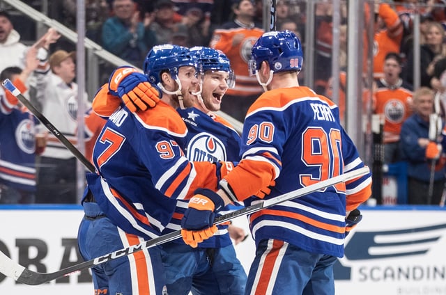 Edmonton Oilers' Connor McDavid (97), Vasily Podkolzin (92) and Corey Perry (90) celebrate a goal against the St. Louis Blues during second period NHL action in Edmonton on Wednesday, April 9, 2025.