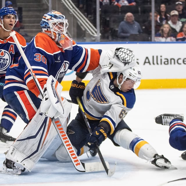 St. Louis Blues' Jake Neighbours (63) gets shoved by Edmonton Oilers goalie Calvin Pickard (30) during third period NHL action in Edmonton on Wednesday, April 9, 2025. THE CANADIAN PRESS/Jason Franson