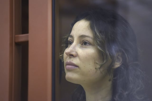 FILE - Ksenia Karelina, also known as Khavana sits in a glass cage in a court room in Yekaterinburg, Russia, Thursday, Aug. 15, 2024.(AP Photo/File)