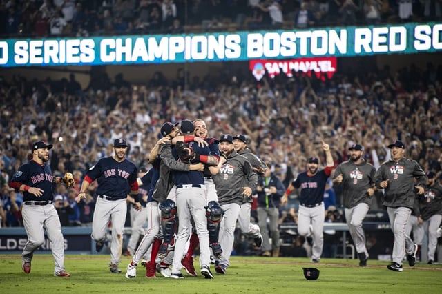 LOS ANGELES, CA - OCTOBER 28: Members of the Boston Red Sox mob David Price #24, Chris Sale #41 and Christian Vazquez #7 of the Boston Red Sox after the final out was recorded to win the 2018 World Series in game five against the Los Angeles Dodgers on October 28, 2018 at Dodger Stadium in Los Angeles, California.