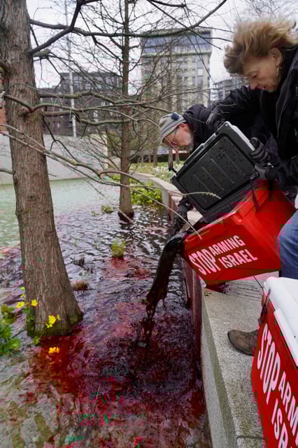 Greenpeace activists pour 300 litres of blood-red dye into the US Embassy in protest at US arms sales to Israel. Photo: Greenpeace