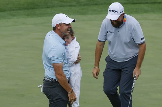 AUGUSTA, GEORGIA - APRIL 09: Rory McIlroy of Northern Ireland consoles his daughter, Poppy McIlroy, as she reacts to crowd noise after holing a putt on the ninth green during the Par Three Contest prior to the 2025 Masters Tournament at Augusta National Golf Club on April 09, 2025 in Augusta, Georgia. (Photo by Harry How/Getty Images)