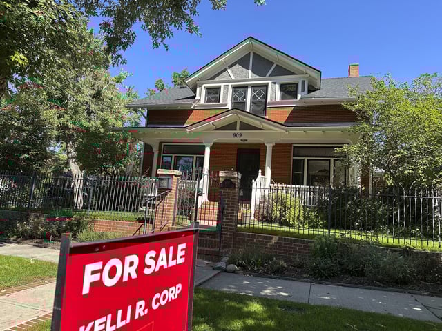 FILE - A for sale sign stands outside a home on the market in the Alamo Placita neighborhood Tuesday, Aug. 27, 2024, in central Denver. (AP Photo/David Zalubowski, File)