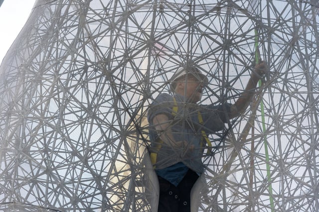 A worker installs electronics inside the R-Evolution statue at Embarcadero Plaza in San Francisco on April 9, 2025, in advance of its public unveiling on April 10.