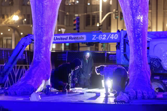 Workers install the decking below the the R-Evolution statue at Embarcadero Plaza in San Francisco on April 9, 2025, in advance of its public unveiling on April 10.