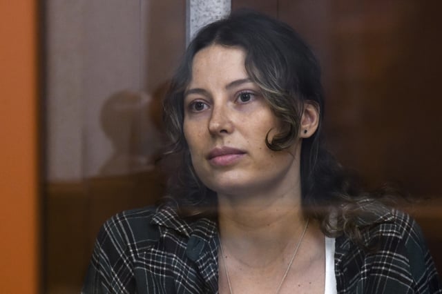 FILE - Ksenia Karelina, also known as Khavana sits in a glass cage in a court room in Yekaterinburg, Russia, Thursday, June 20, 2024. (AP Photo, File)