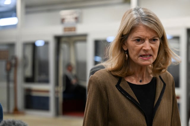 U.S. Senator Lisa Murkowski (R-AK) walks to the chamber as senators grapple with making a deal to fund the U.S. government and avert a shutdown, on Capitol Hill in Washington, D.C., U.S., March 14, 2025. REUTERS/Annabelle Gordon