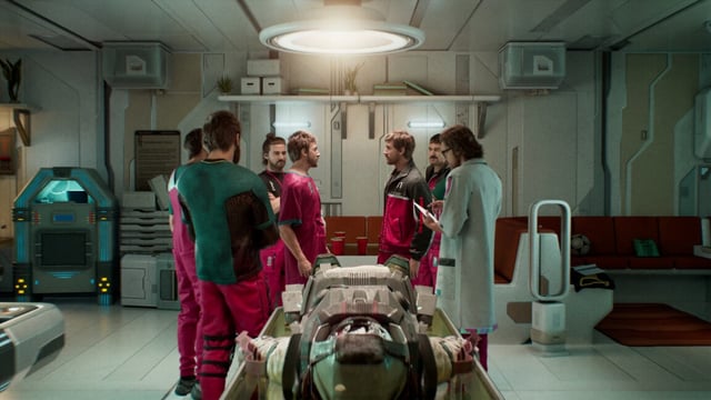 Screenshot from The Alters, featuring numerous versions of a person standing over yet another version, on a table.